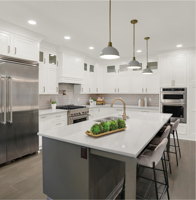 Stylish home kitchen with sleek white cabinets and center island remodeled by The Trim Wright.