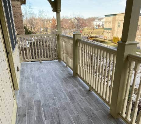 Walk out balcony refinished with new railing and flooring by The Trim Wright.