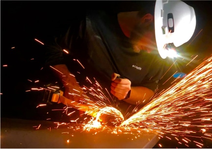 The Trim Wright craftsman using an angle grinder.